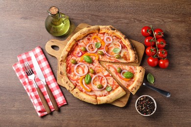 Photo of Delicious vegetarian pizza served on wooden table, flat lay