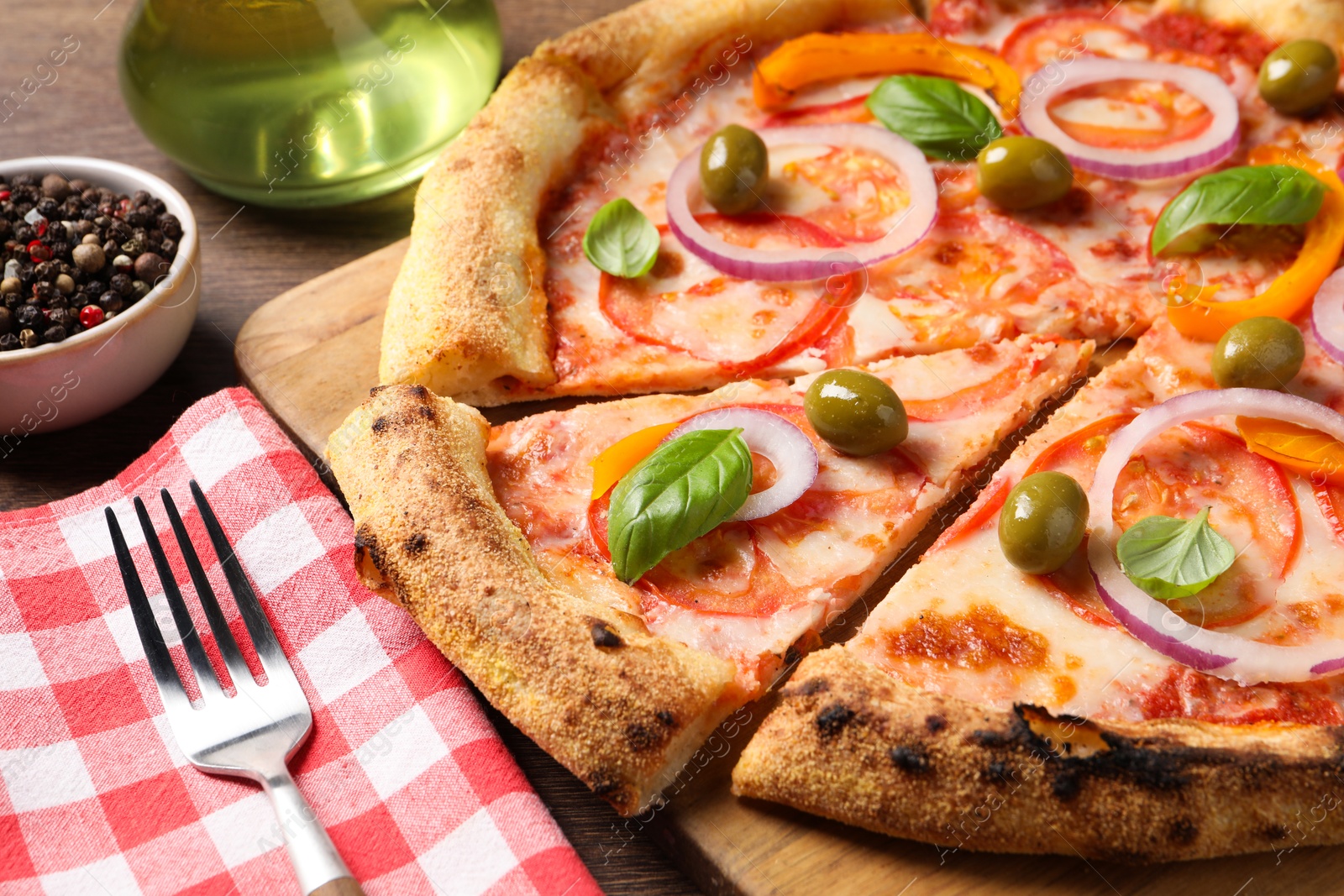 Photo of Delicious vegetarian pizza served on wooden table, closeup