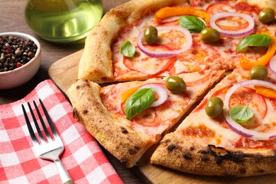 Photo of Delicious vegetarian pizza served on wooden table, closeup