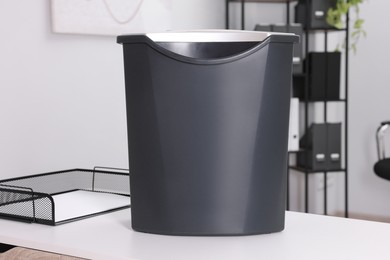 Photo of Paper shredder with bin on white table in office