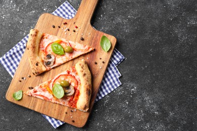 Photo of Cut delicious vegetarian pizza and spices on grey table, top view. Space for text