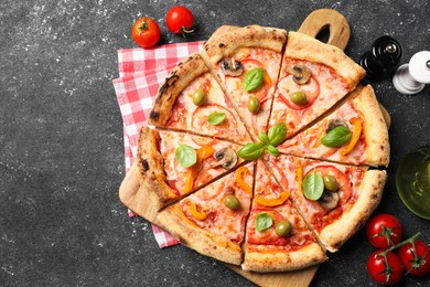 Photo of Cut delicious vegetarian pizza, tomatoes and spices on grey table, top view. Space for text