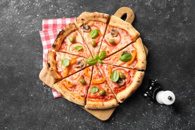 Photo of Cut delicious vegetarian pizza and spices on grey table, top view