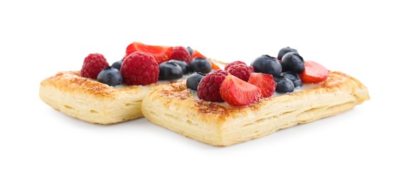 Photo of Tasty puff pastries with berries isolated on white