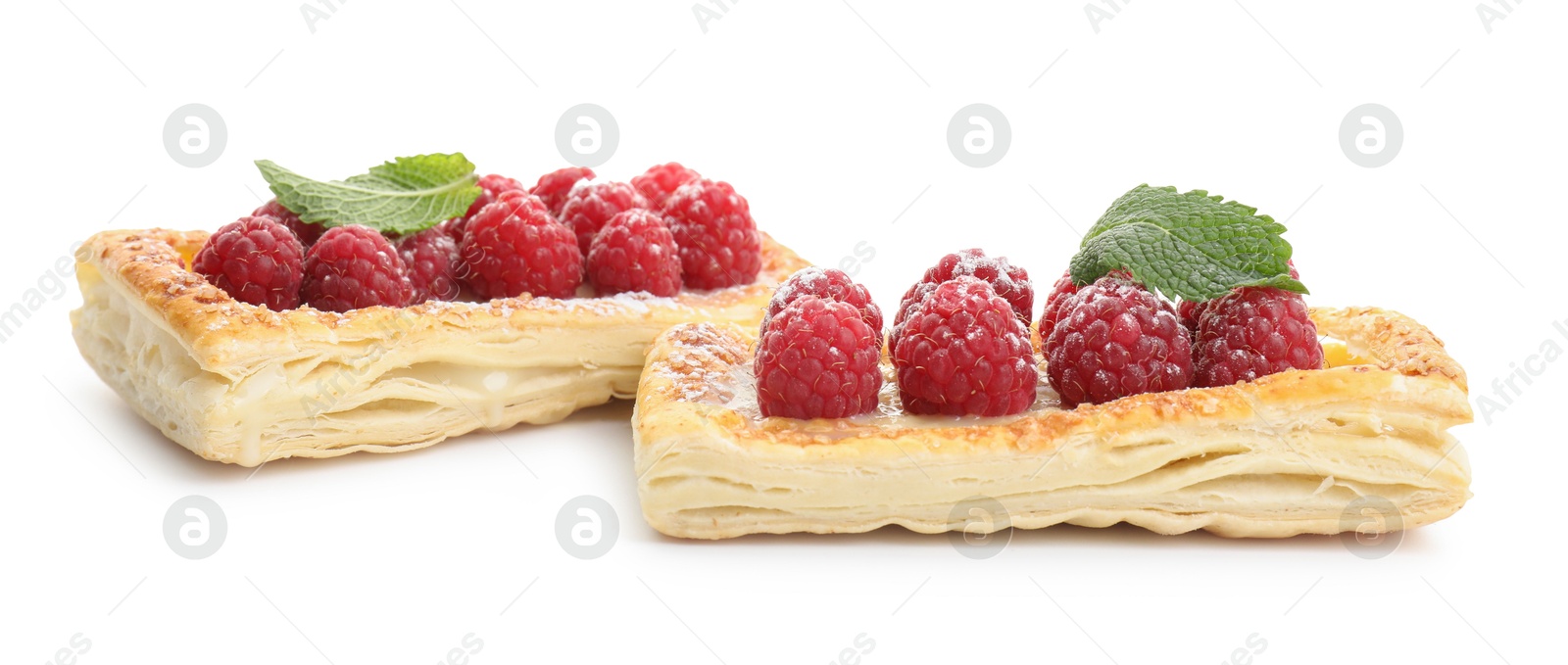 Photo of Tasty puff pastries with raspberries and mint isolated on white