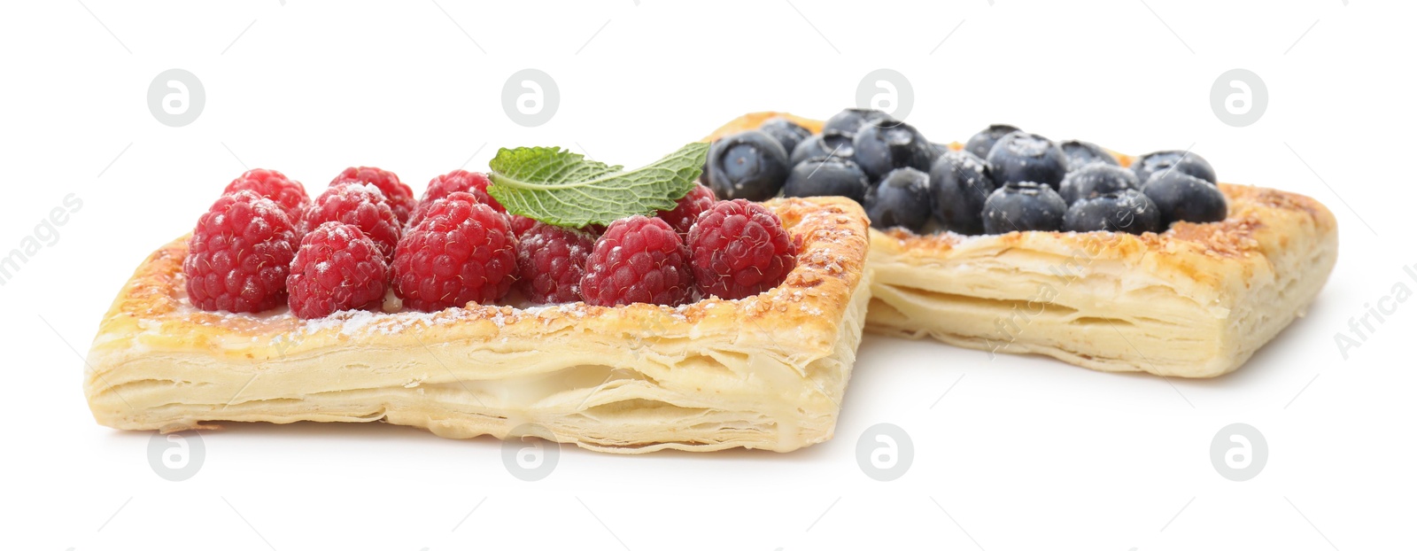 Photo of Tasty puff pastries with berries isolated on white