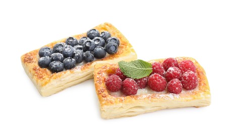 Tasty puff pastries with berries isolated on white