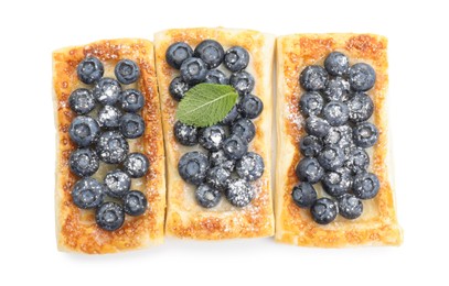 Photo of Tasty puff pastries with blueberries isolated on white, top view