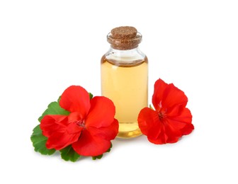 Photo of Bottle of geranium essential oil and beautiful flowers isolated on white