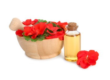 Photo of Bottle of geranium essential oil, mortar and pestle with beautiful flowers isolated on white