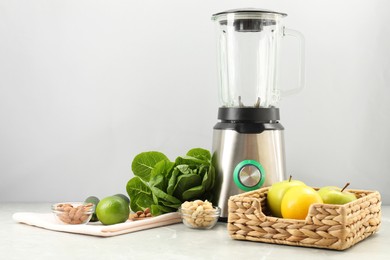 Blender and healthy products on grey marble table