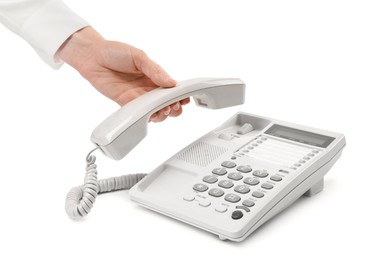 Photo of Woman taking handset of telephone on white background, closeup