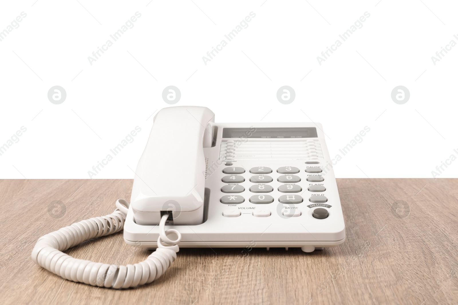 Photo of Telephone on wooden table against light background