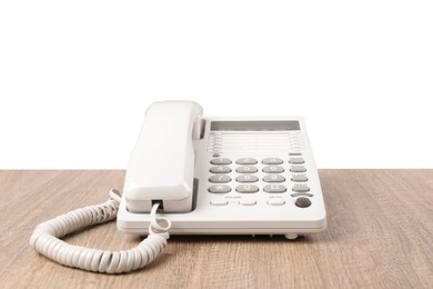 Telephone on wooden table against light background