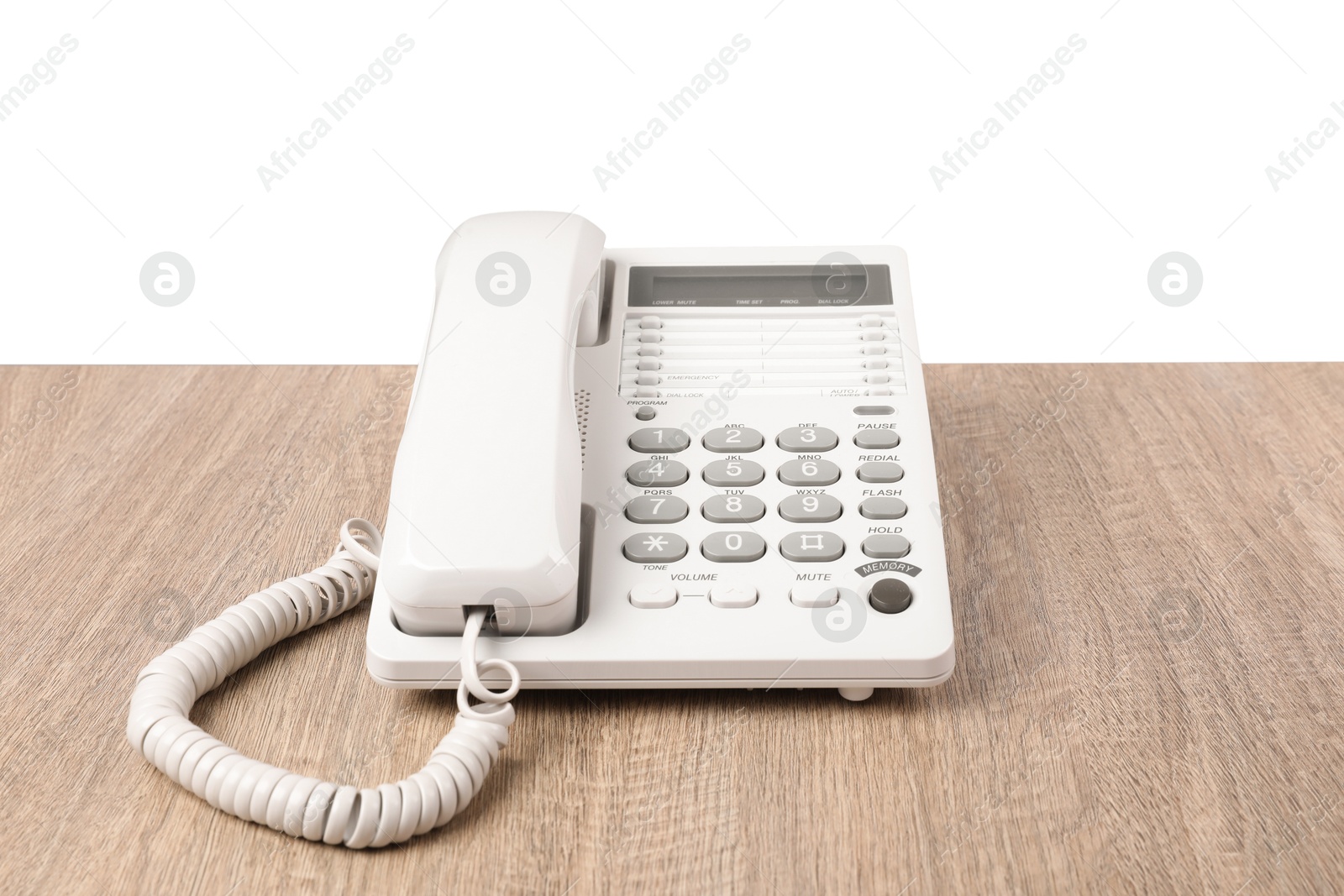 Photo of Telephone on wooden table against light background