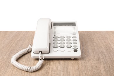 Telephone on wooden table against light background