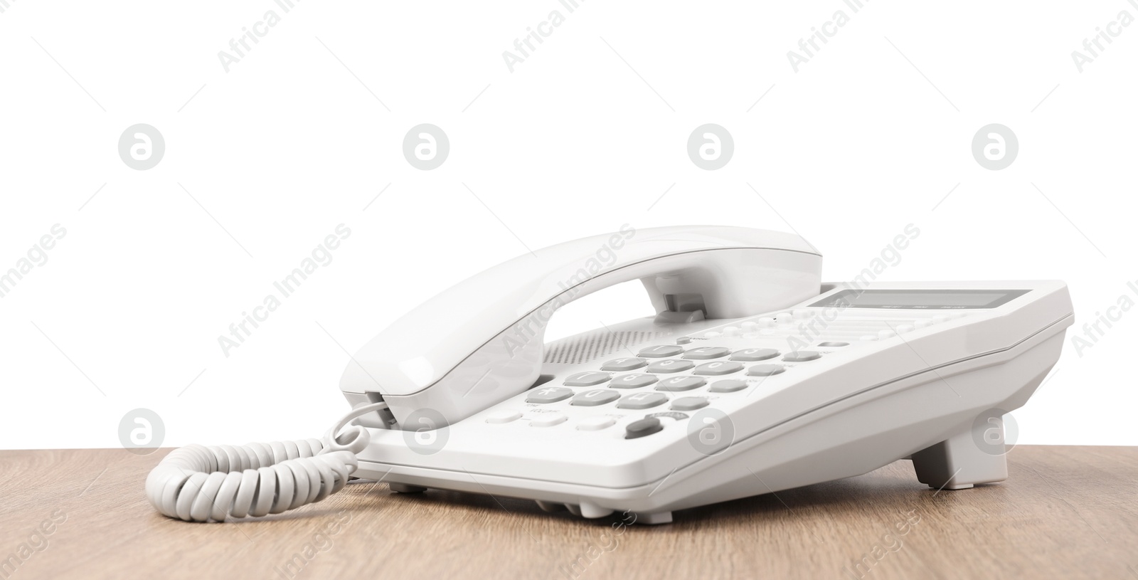 Photo of Telephone on wooden table against light background