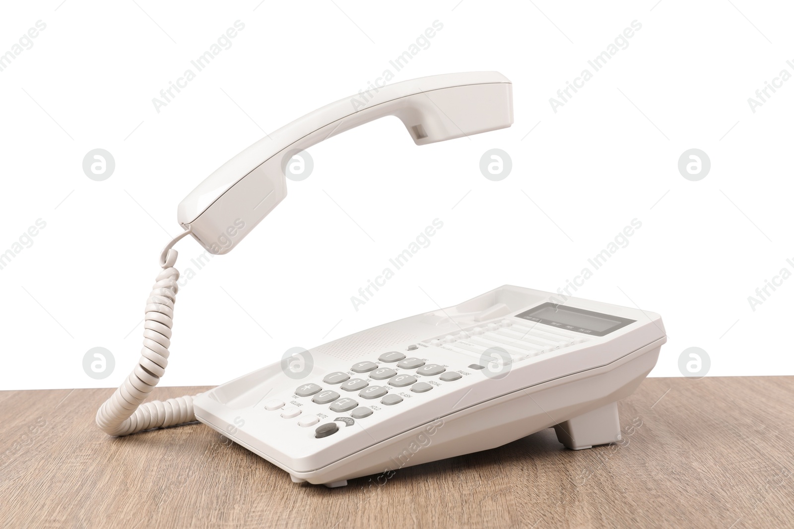 Photo of Telephone on wooden table against light background