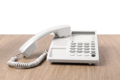 Photo of Telephone on wooden table against light background