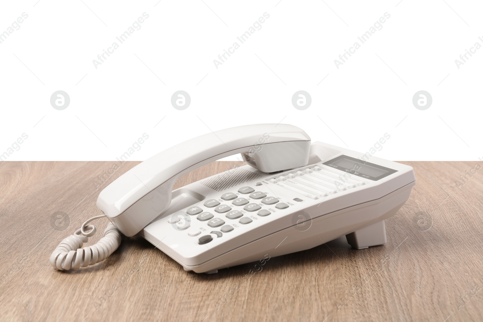 Photo of Telephone on wooden table against light background