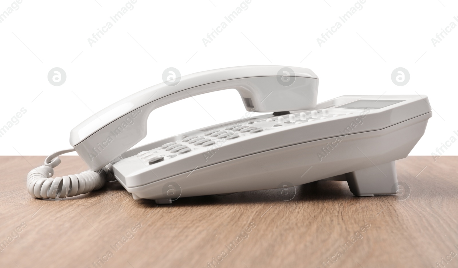 Photo of Telephone on wooden table against light background