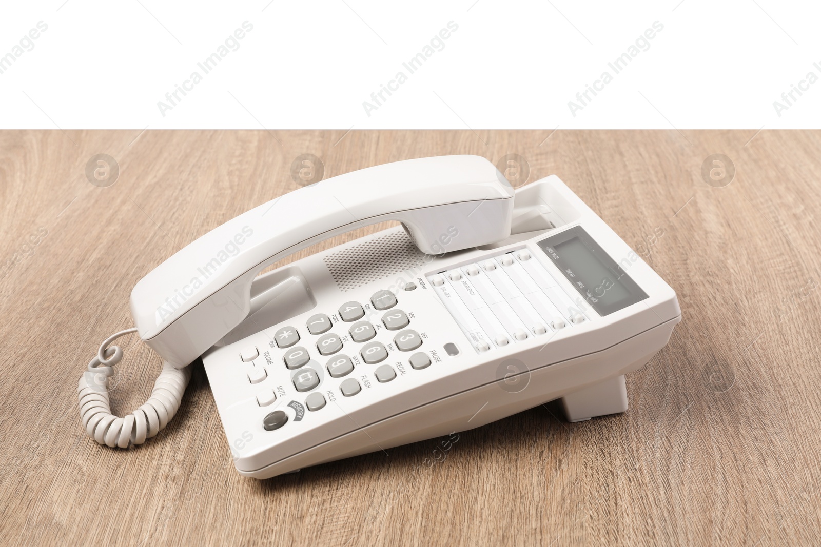 Photo of Telephone on wooden table against light background