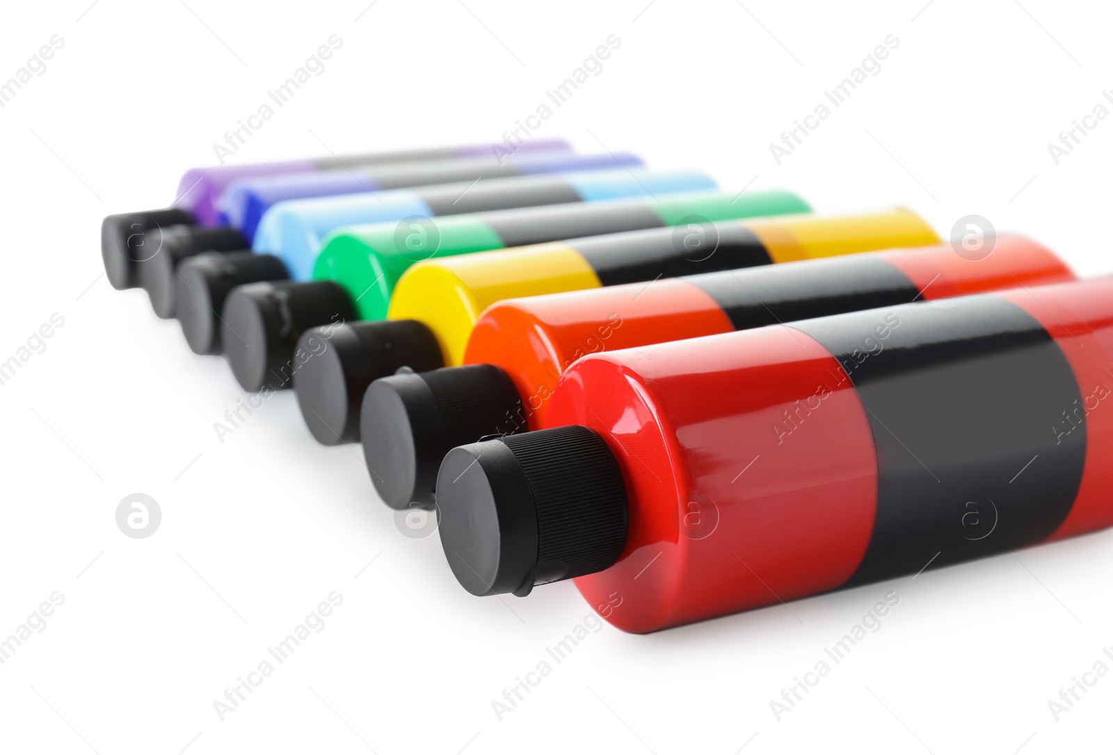 Photo of Acrylic paints of different colors in bottles isolated on white