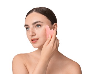 Beautiful young woman doing facial massage with gua sha tool on white background