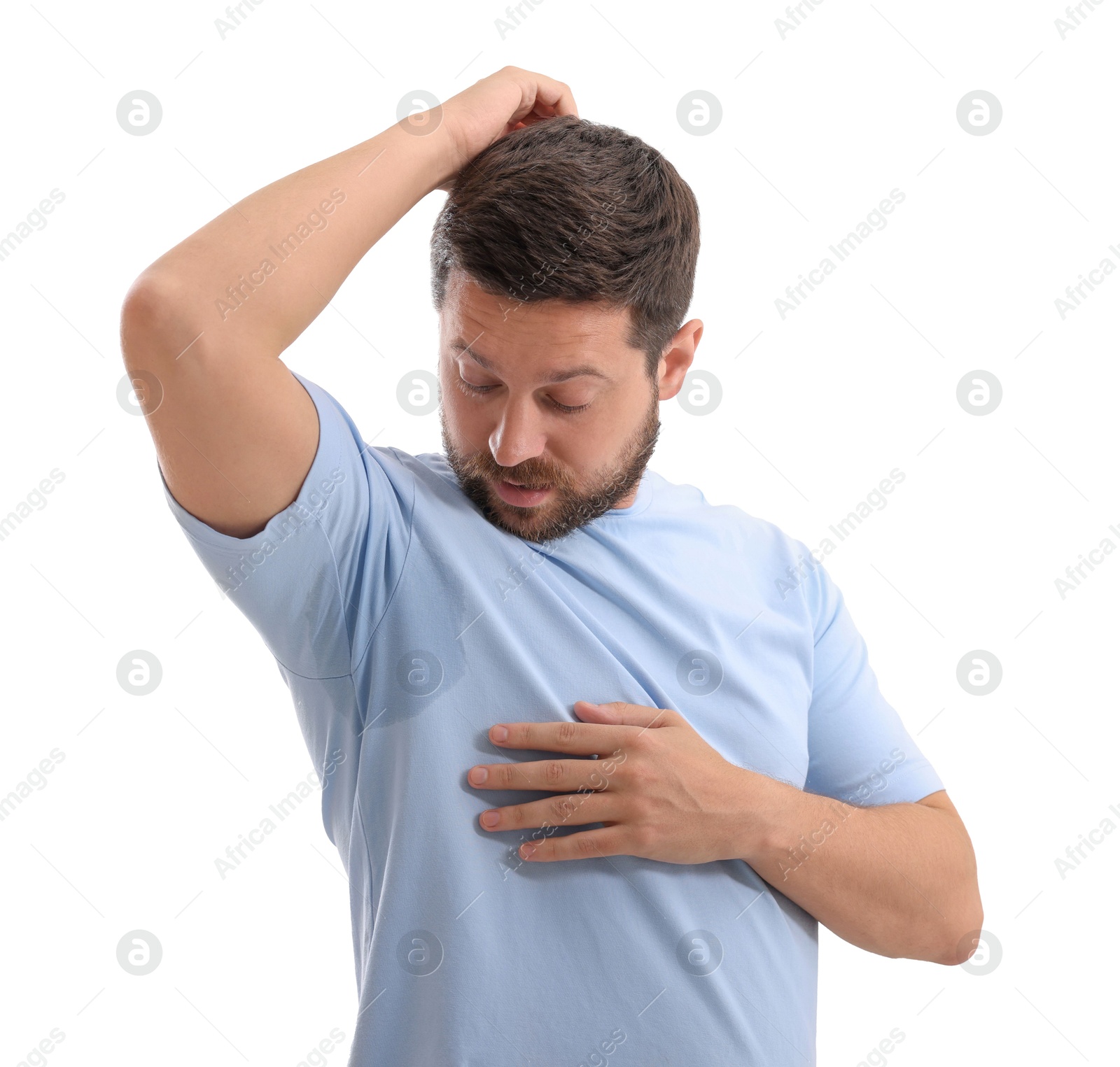 Photo of Emotional man in t-shirt before using deodorant on white background