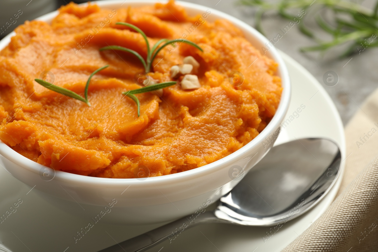 Photo of Delicious mashed sweet potatoes served on table, closeup