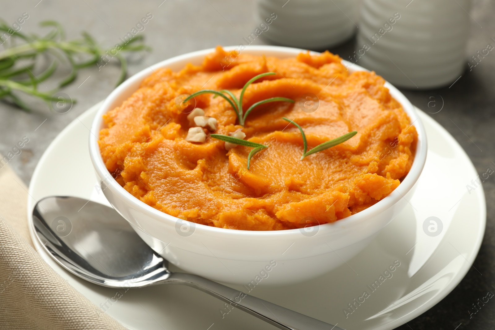 Photo of Delicious mashed sweet potatoes served on table, closeup