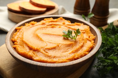 Photo of Delicious mashed sweet potatoes in bowl on table, closeup