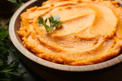 Photo of Delicious mashed sweet potatoes in bowl on table, closeup