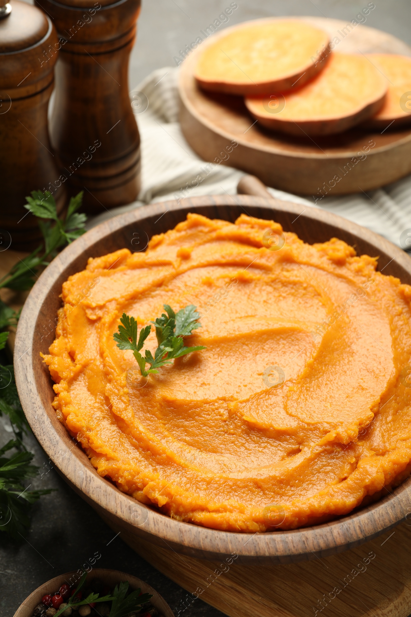 Photo of Delicious mashed sweet potatoes in bowl on table, closeup