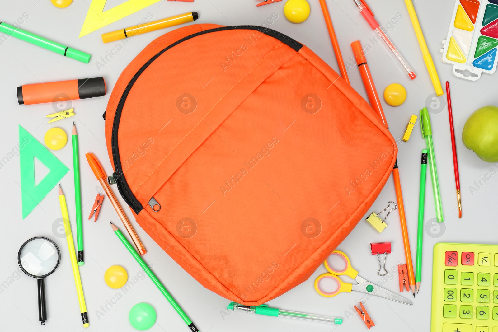 Photo of Backpack and different school supplies on light gray background, flat lay