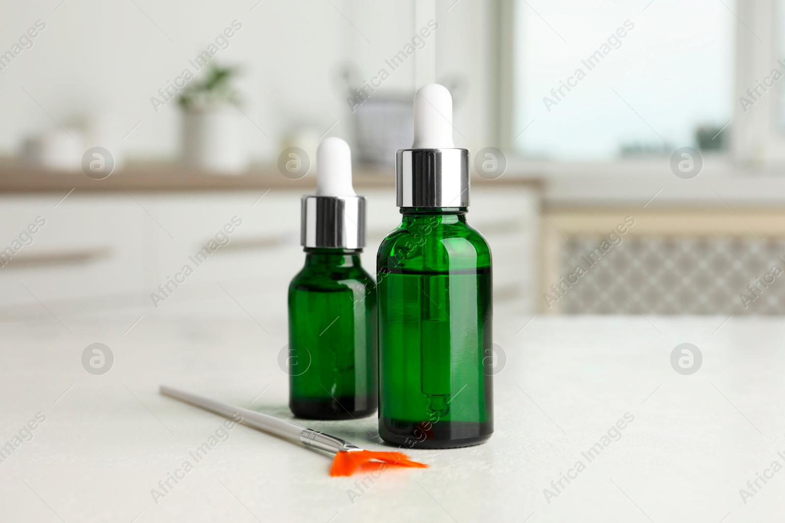 Photo of Peeling procedure. Bottles of chemical peel and brush on white table indoors