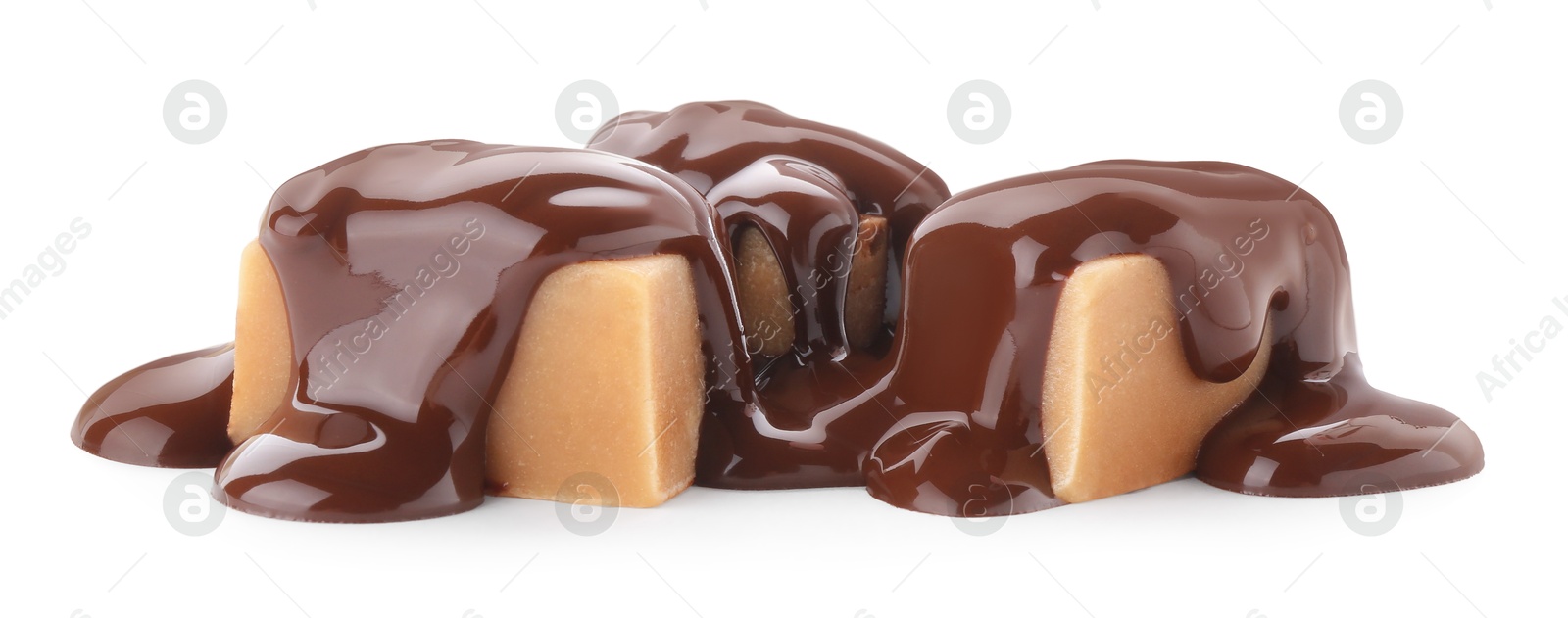 Photo of Delicious caramel candies with melted chocolate isolated on white