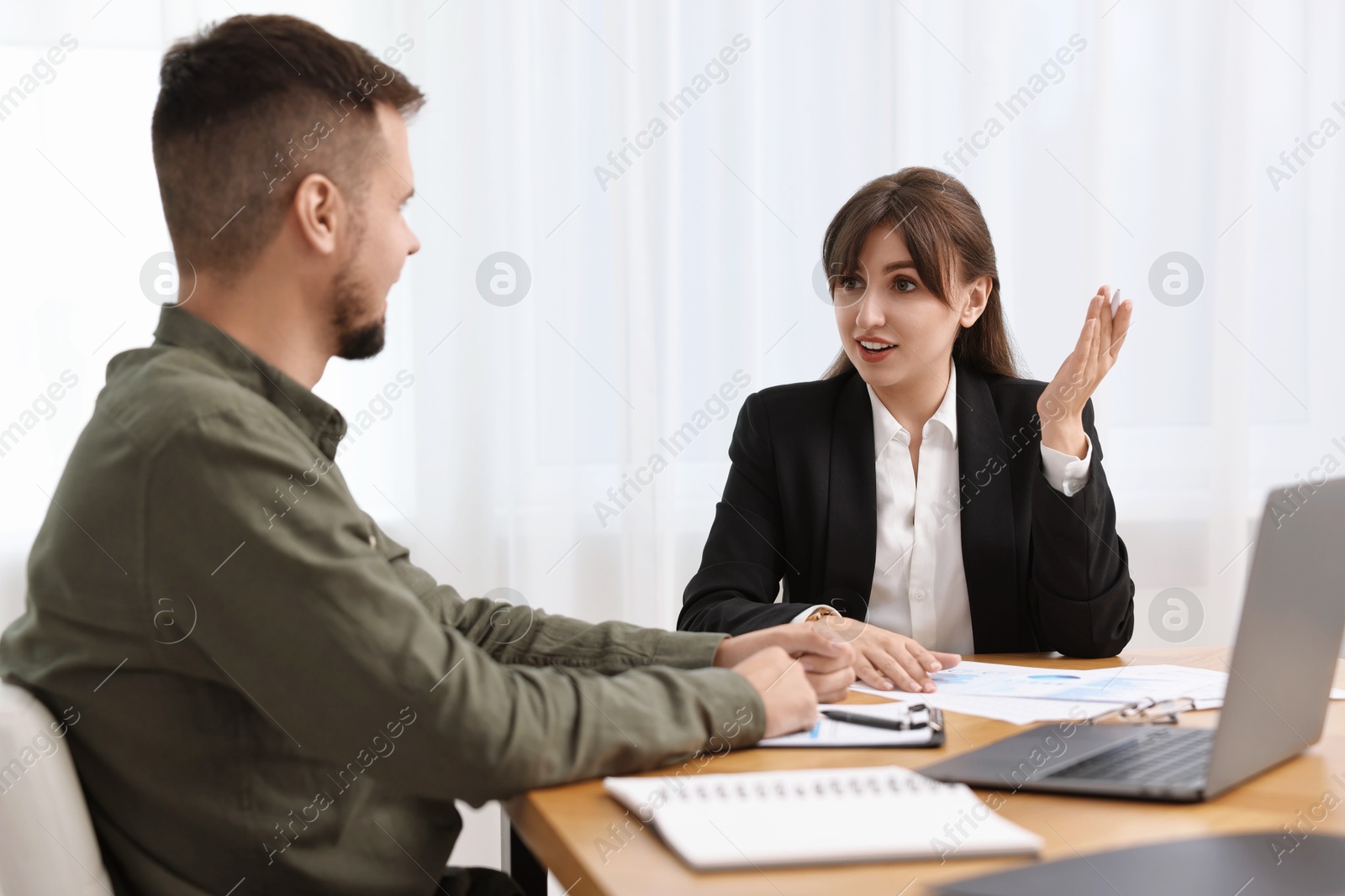 Photo of Consultant working with partner at table in office. Business meeting