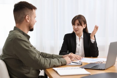 Consultant working with partner at table in office. Business meeting