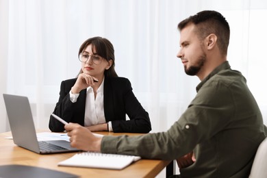 Photo of Consultant working with partner at table in office. Business meeting