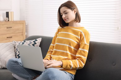 Teenager working with laptop at home. Remote job