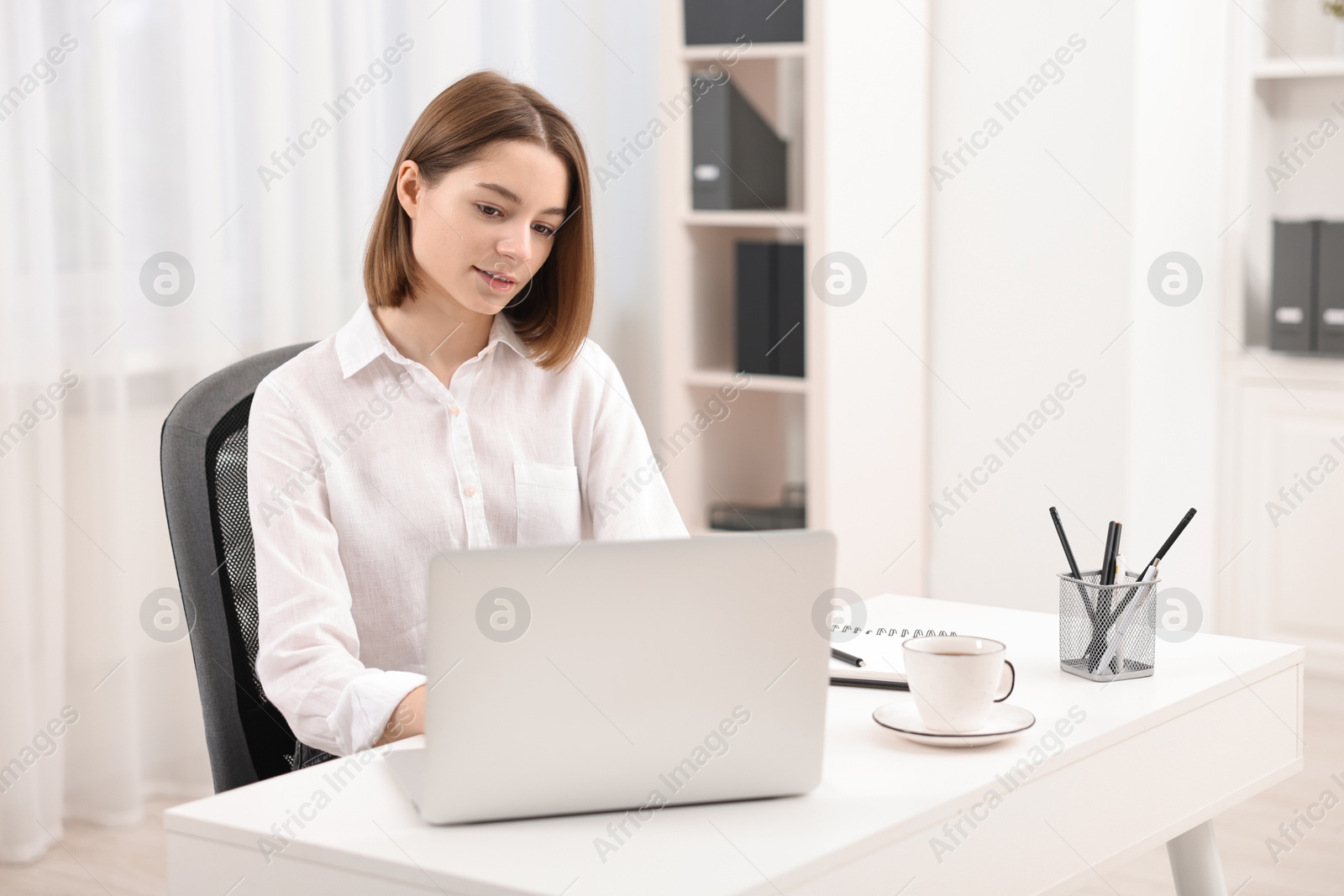 Photo of Teenager working with laptop at home. Remote job