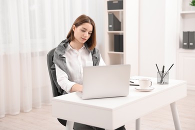 Teenager working with laptop at home. Remote job