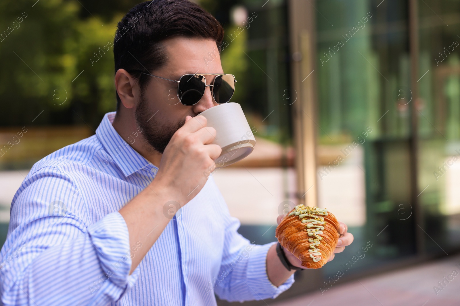 Photo of Man having tasty breakfast in outdoor cafe