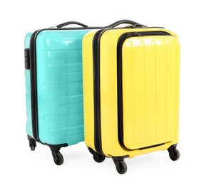 Two new yellow and light blue suitcases isolated on white