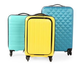 Photo of New yellow and light blue suitcases isolated on white