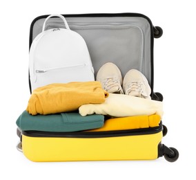 One new yellow suitcase with personal belongings isolated on white