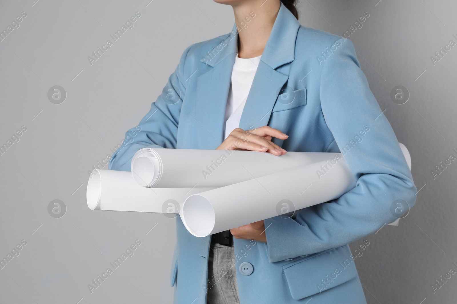 Photo of Engineer with drafts on grey background, closeup