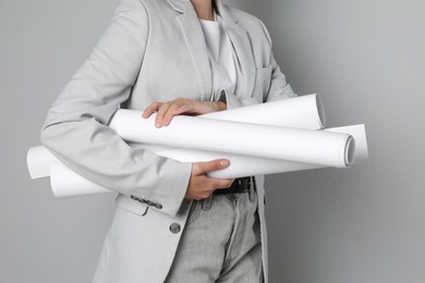 Photo of Engineer with drafts on grey background, closeup