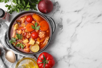 Photo of Tasty homemade stew with vegetables on white marble table, flat lay. Space for text